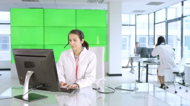 Healthcare Worker Assisting Patient Phone Green Background — Stock Video