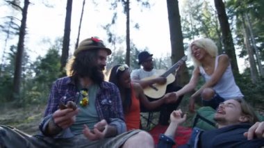Ormanda kamp, gitar çalıyor ve şarkı 4 k mutlu hipster arkadaşlar