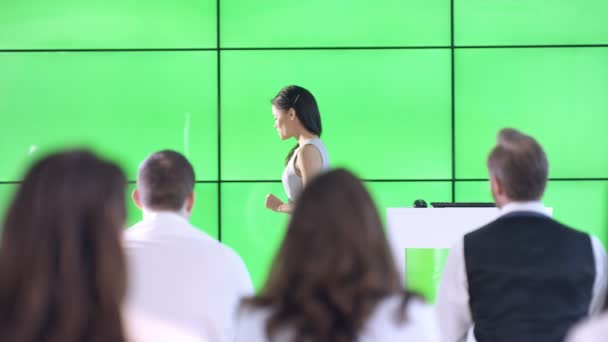 Young Businesswoman Giving Presentation Interacting Green Screen Video Wall — Stock Video