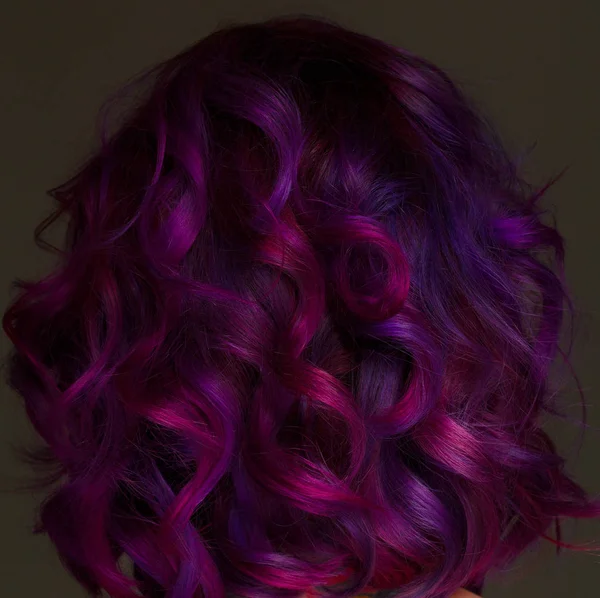 Portrait ofmodel with purple hair over grey background