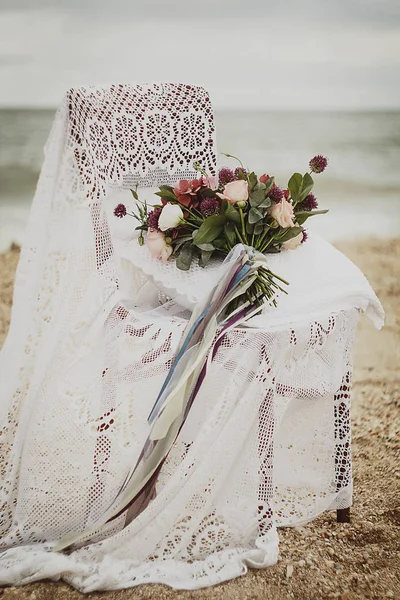 Beautiful Wedding bouquet in a chair on a seaside — Stock Photo, Image