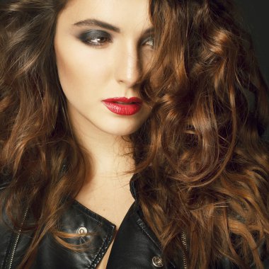 Siyah deri ceket gri b üzerinde poz güzel genç kadın