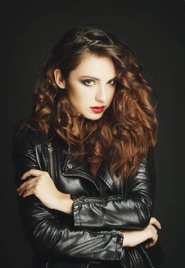 Siyah deri ceket gri b üzerinde poz güzel genç kadın