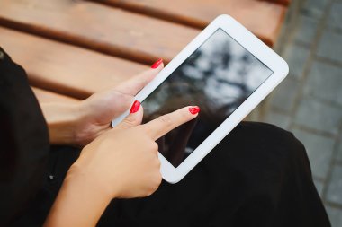 Tablet açık havada tutan kadının elleri