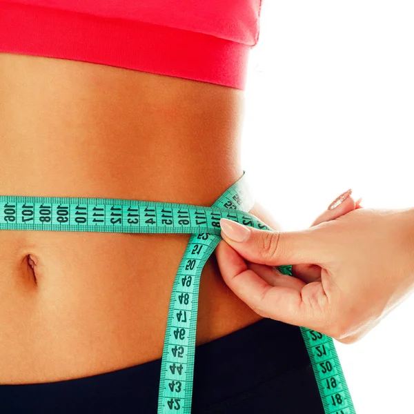 Woman measuring her waist over white background. Wellness concep — Stock Photo, Image