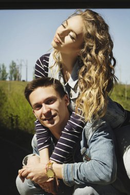 Genç güzel çift giyen kot giysiler ışığında moda.