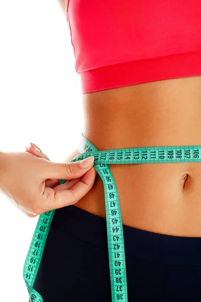 Woman measuring her waist over white background. Wellness concep — Stock Photo, Image