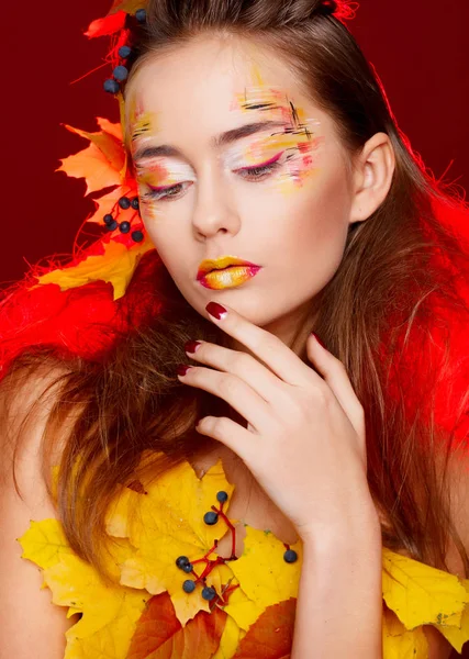 Beautiful young woman with autumn make up posing in studio over Royalty Free Stock Images