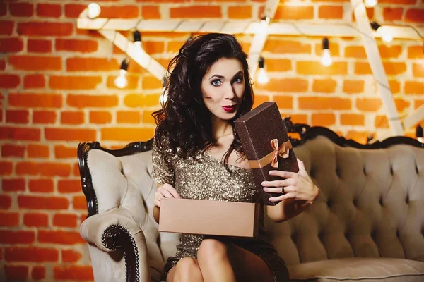 Portrait of young happy beautiful woman in golden dress holding — Stock Photo, Image