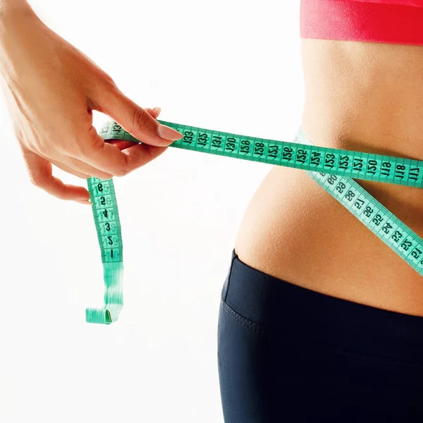 Woman measuring her waist over white background. Wellness concep — Stock Photo, Image