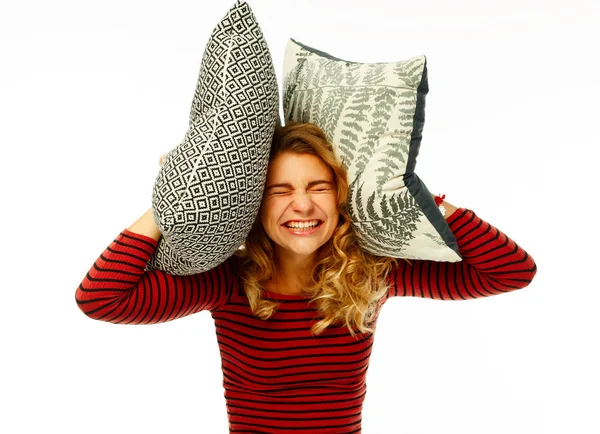 Young beautiful woman covering her head with two pillows and scr — Stock Photo, Image