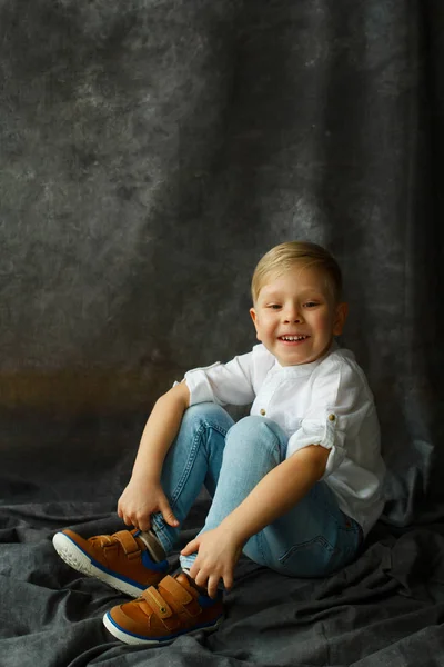 Portrait of little pretty boy over grey textile background — Stock Photo, Image