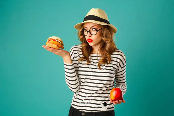 Portrét mladé krásné blond žena v klobouku drží červené jablko — Stock fotografie