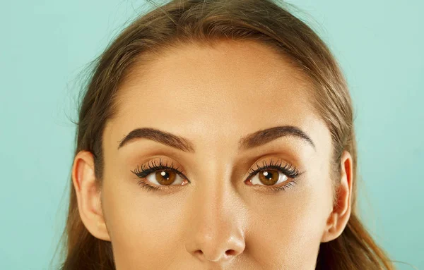 Close up pictures of woman's eye over blue background — Stock Photo, Image