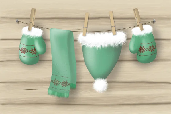 resimde yeşil eldiven şapka ve atkı clothespins ile bir ip üzerinde