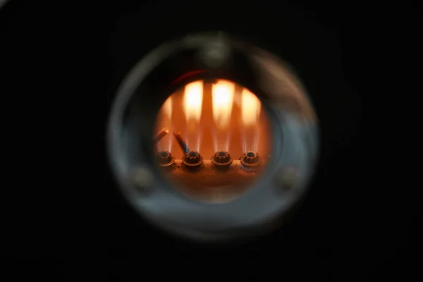 Flame of burning nozzles in the window of coffee roasting equipment. Close-up.