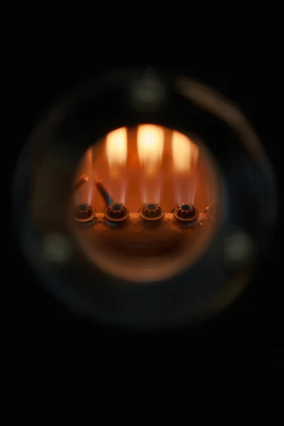 Coffee processing technology. Flame of burning nozzles in the window of coffee roasting equipment. Close-up.