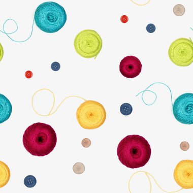 Multi-colored threads for knitting and buttons on a white surface. Top view.