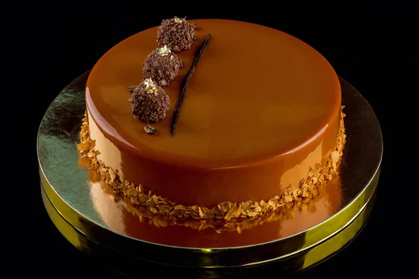 Beautiful designer cake in chocolate glaze. Close-up.