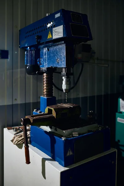 Drilling machine in a car workshop.