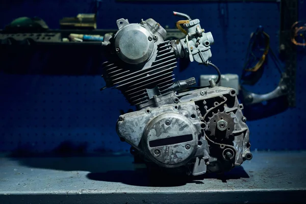 View of a faulty motorcycle engine in a motorcycle service.