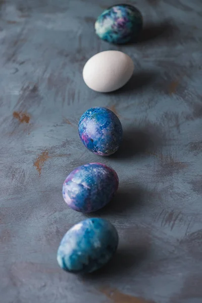 Easter holiday. Easter colorful eggs on a blue surface.