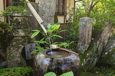 Traditional japanese bamboo purification fountain for purification at entrance of the Japanese temple. clipart