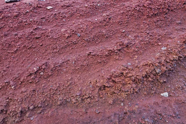 A cut of soil with rocks and red soil — Stock Photo, Image