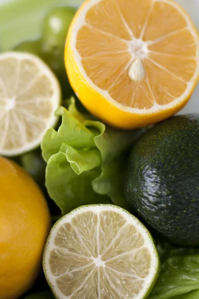 Šťavnaté citrony a limetky, zeleného salátu a avokádo — Stock fotografie