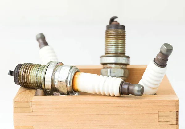 Spark plug in wood box — Stock Photo, Image