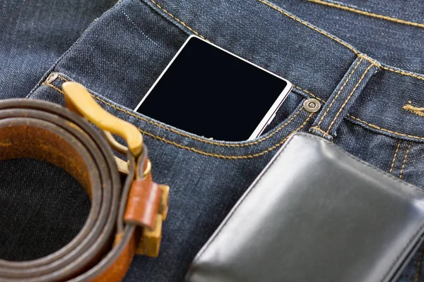 Wallet and smartphone on denim jeans — Stock Photo, Image