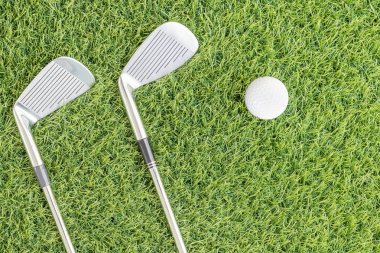 Yeşil çimenlerin üzerinde Golf Kulübü ve Golf topu