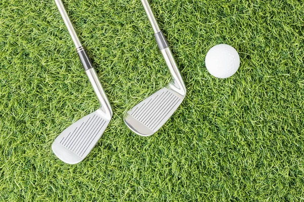 Golf club and Golf ball on green grass