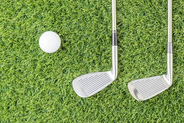 Golf club and Golf ball on green grass