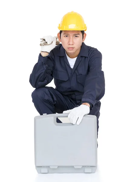 Young handyman sitting with his tool box — Stock Photo, Image