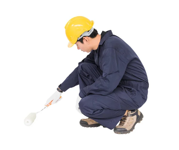 Worker in a uniform using a paint roller is painting invisible f — Stock Photo, Image