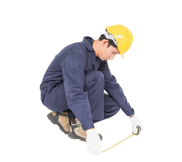 Young worker in unifrom with tape measure isolated on white — Stock Photo, Image