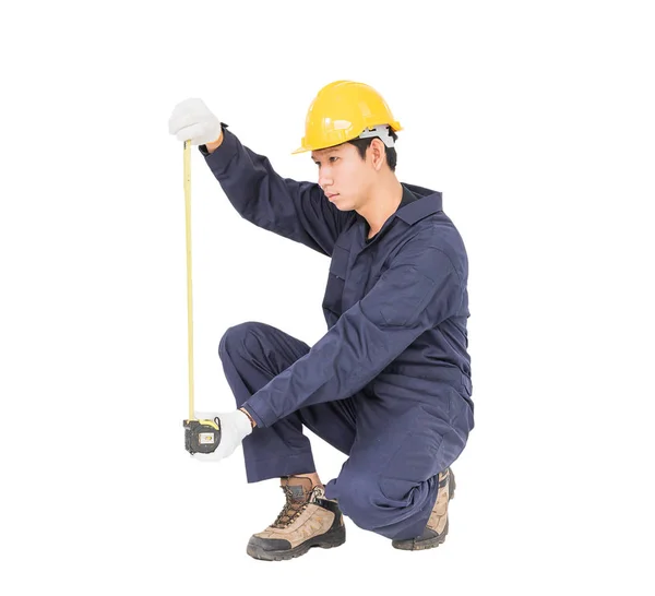 Young worker in unifrom with tape measure isolated on white — Stock Photo, Image