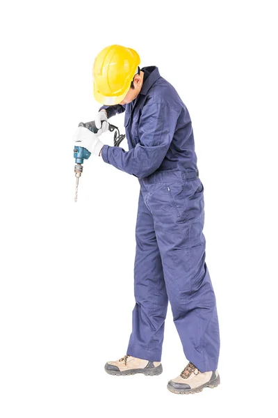 Разнорабочий в униформе, стоящий со своей электрической дрелью — стоковое фото