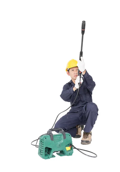 Young man sitting and holding high pressure water gun — Stock Photo, Image