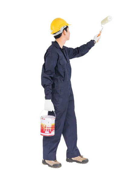 Worker in uniform using paint roller is painting invisible wall — Stock Photo, Image