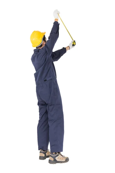 Young worker in unifrom with tape measure on white — Stock Photo, Image