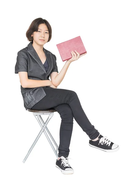 Woman reading a book sitting on chair — Stock Photo, Image