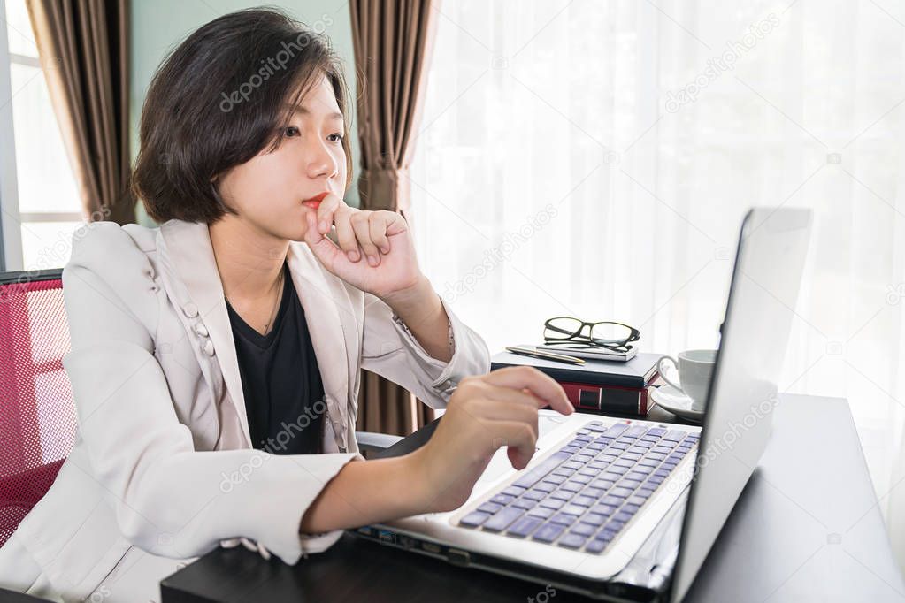 Young woman in smart casual wear working on laptop