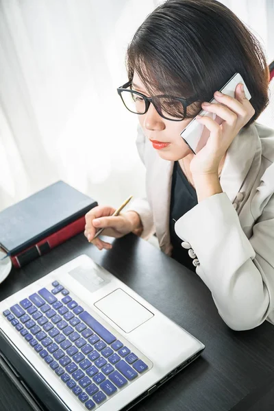 Junge Frau in schicker Freizeitkleidung arbeitet am Laptop — Stockfoto