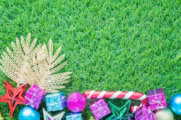 Christmas decoration on green grass with copy space — Stock Photo, Image