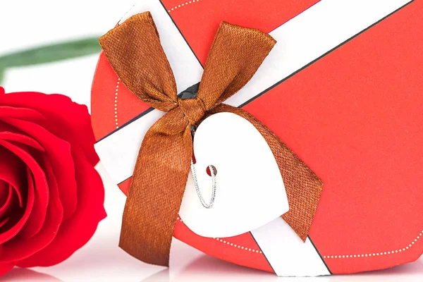 Close up vermelho rosa e caixa em forma de coração no branco — Fotografia de Stock