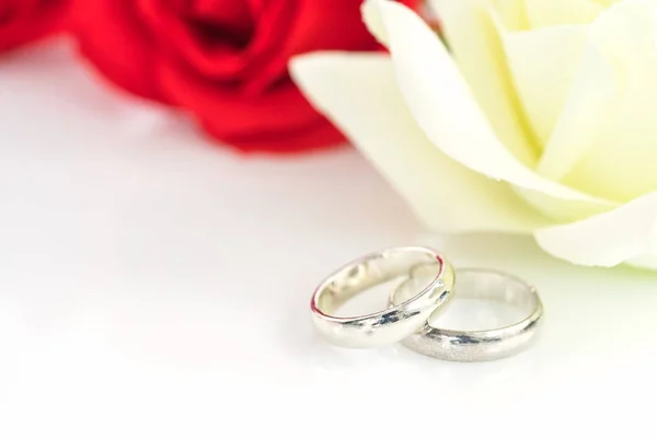 Rosa vermelha e anel de casamento em branco — Fotografia de Stock