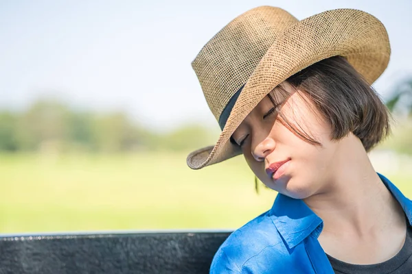 Woman wear hat sit sleep in countryside