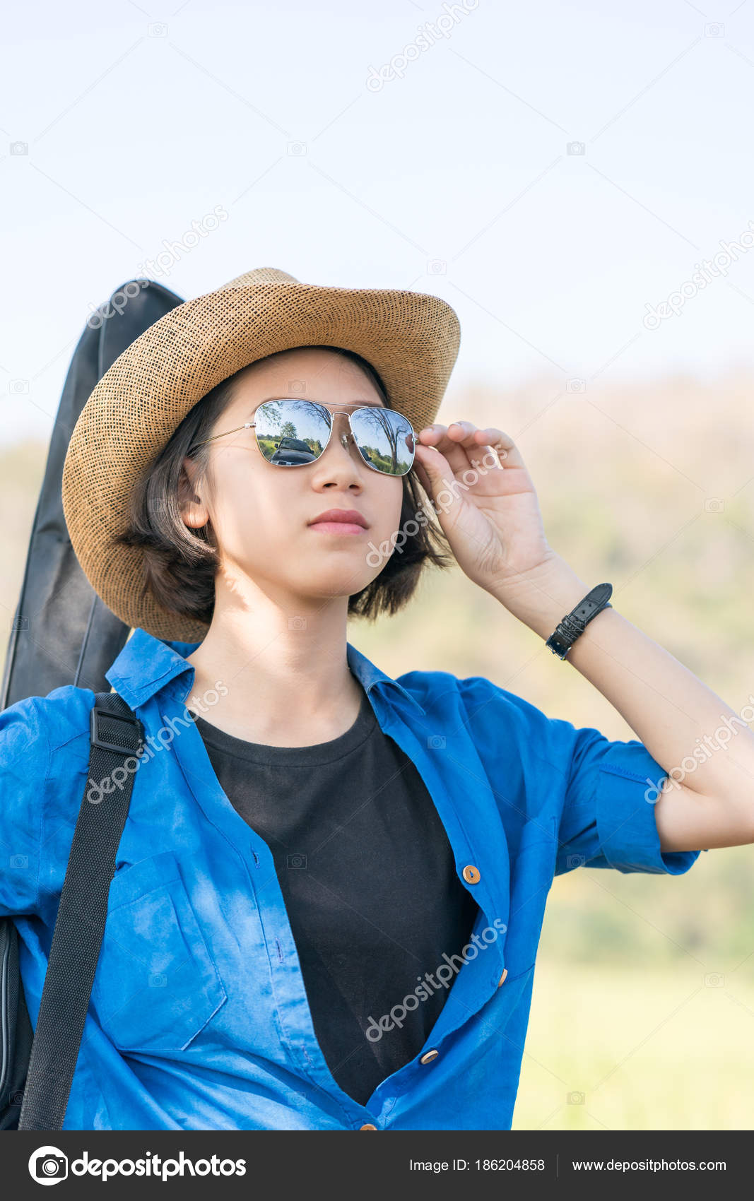 Woman Wear Hat Walking And Carry Her Guitar Bag Stock Photo